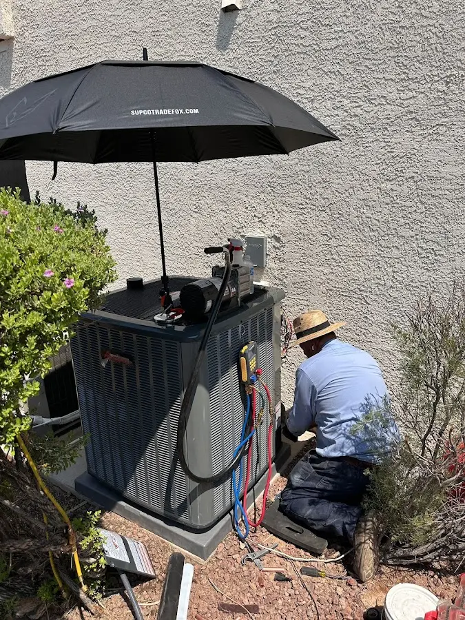 HVAC technician performing outdoor AC maintenance in Doraville