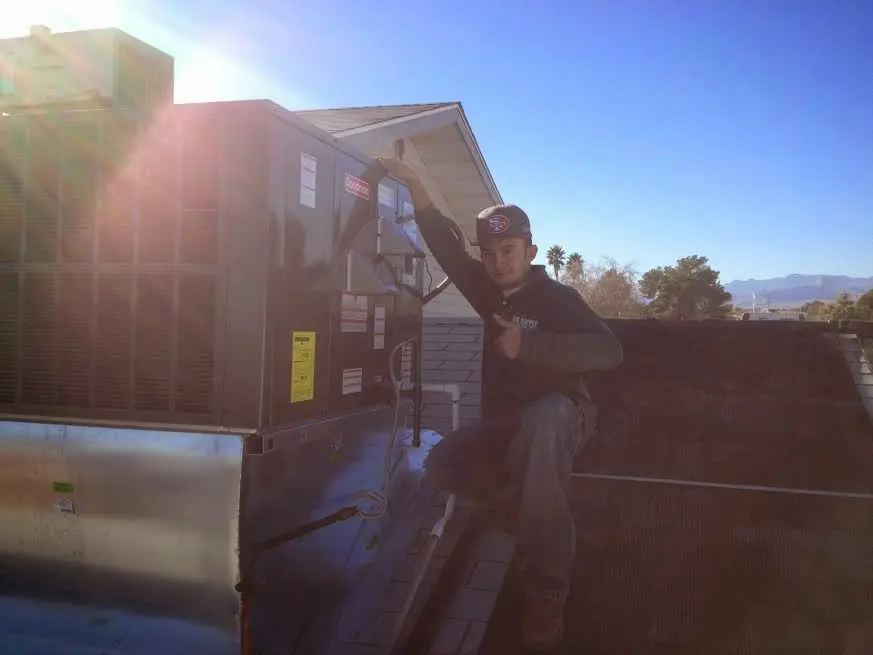 HVAC technician performing HVAC Inspection on a rooftop unit in Doraville